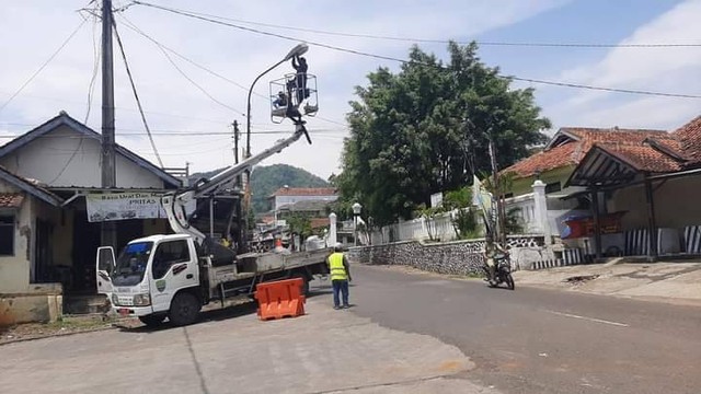 Petugas dari Dishub Sumedang memperbaiki salah satu lampu penerangan jalan yang mati di sekitar Alun-alun Wadu. Foto: Istimewa/Diskominfosanditik Sumedang