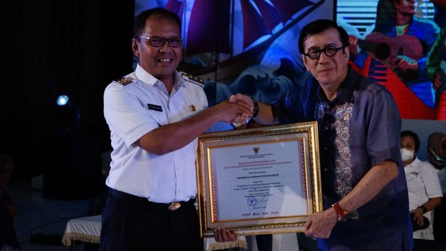 Menkum HAM, Yasonna Laoly, memberikan piagam penghargaan  kepada Pemerintah kota Makassar oleh Wali Kota Makassar, Mohammad Ramdhan Pomanto. (Foto: Yuto/Kemenkumham)