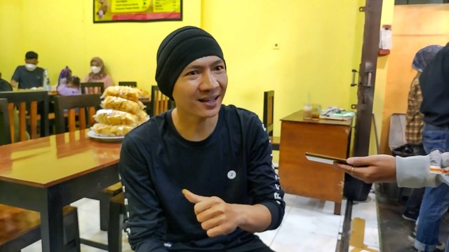 Seorang penjual sate padang di Yogyakarta bernama Ropi Pujiono Putra (30) viral lantaran mirip dengan penyanyi Anji. Foto: Arfiansyah Panji Purnandaru/kumparan