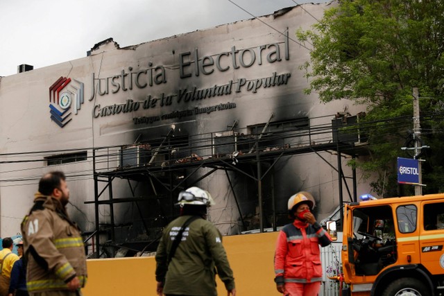 Petugas pemadam kebakaran berusaha memadamkan api di markas Pengadilan Tinggi Paraguay of Electoral Justice (TSJE), di Asuncion, Paraguay. Foto: Cesar Olmedo/REUTERS