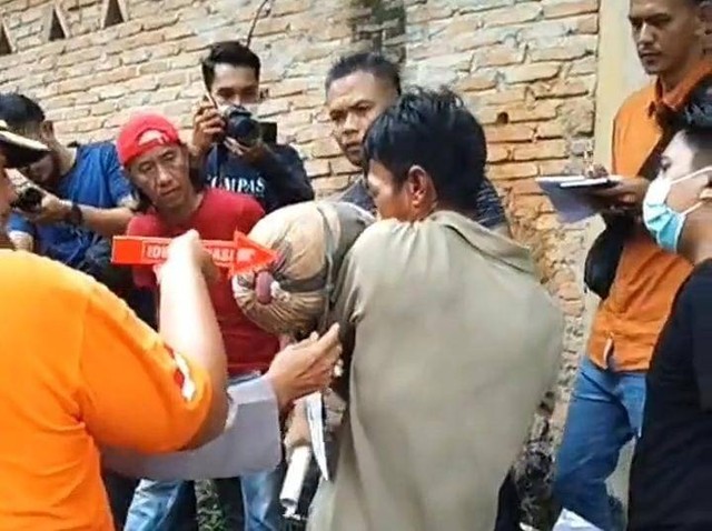 Tersangka Erwin mencium Zahra terlebih dahulu sebelum dibuang ke septic tank. | Foto: Bella Sardio/ Lampung Geh