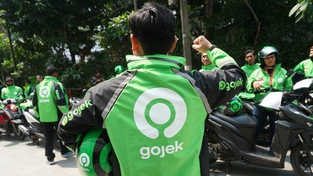 Pengemudi Go-Jek menunjukan jaket dengan logo baru. Foto: Iqbal Firdaus/kumparan