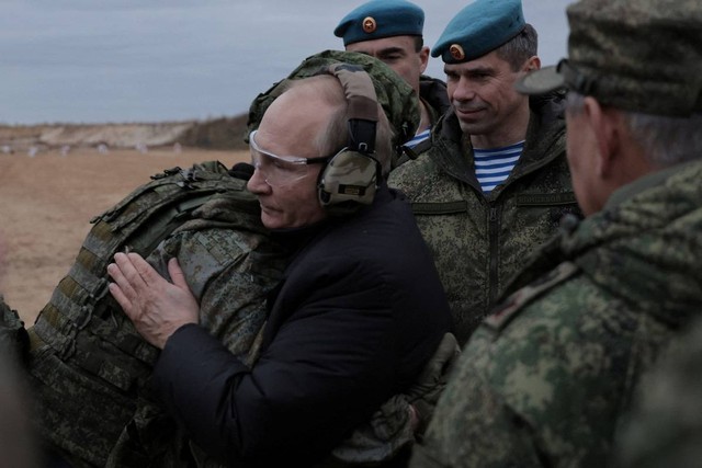 Presiden Rusia Vladimir Putin memeluk seorang prajurit di pusat pelatihan Distrik Militer Barat untuk pasukan cadangan yang dimobilisasi, di Wilayah Ryazan, Rusia Kamis (20/10/2022). Foto: Russian Defence Ministry/Reuters