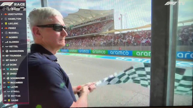 Ekspresi muka cemberut CEO Apple Tim Cook melambaikan bendera finish balap F1. Foto: Peter Lustig/YouTube