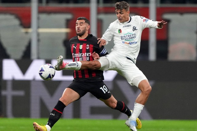 Pemain AC Milan Theo Hernandez beraksi bersama pemain Spezia Daniel Maldini di Stadion San Siro, Milan, Italia, Sabtu (5/11/2022). Foto: Daniele Mascolo/REUTERS