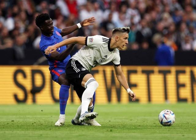 Bukayo Saka dari Inggris duel dengan Nico Schlotterbeck dari Jerman saat pertandingan UEFA Nations League di Allianz Arena, Munich, Jerman. Foto: Lee Smith/Reuters