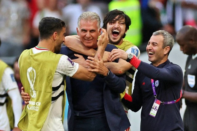 Pemain Iran Sardar Azmoun merayakan dengan pelatih Iran Carlos Queiroz setelah pertandingan usai Wales pada Piala Dunia FIFA Qatar 2022 di Stadion Ahmad Bin Ali, Al Rayyan, Qatar, Jumat (25/11/2022). Foto: Carl Recine/REUTERS