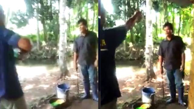Capture potongan video yang viral di mana seorang pria berbaju Bakamla memegang senjata api berhadapan dengan seorang pria memegang senjata tajam jenis parang.
