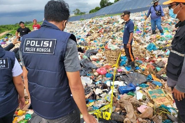 Aparat kepolisian mengevakuasi jenazah bayi yang ditemukan di tumpukan sampah TPA Punggur (Foto: Istimewa)