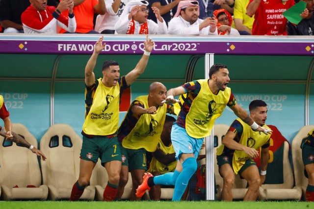 Cristiano Ronaldo merayakan dari bangku cadangan setelah Pepe mencetak gol kedua mereka saat pertandingan Portugal vs Swiss di babak 16 besar Piala Dunia Qatar 2022, Selasa (6/12/2022). Foto: Suhaib Salem/REUTERS
