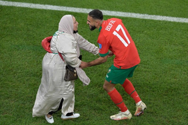 Gelandang Maroko, Sofiane Boufal merayakan bersama ibunya setelah lolos ke babak semi final setelah mengalahkan  Portugal 1-0 dalam pertandingan sepak bola perempat final Piala Dunia Qatar 2022, di Stadion Al-Thumama, Doha, Qatar, Sabtu (10/12/2022). Foto: JUAN MABROMATA/AFP