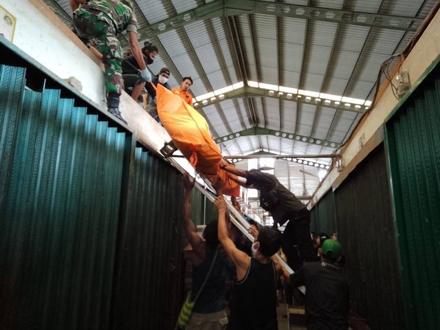 Warga dan petugas mengevakuasi mayat di Pasar Flamboyan Pontianak. Foto: Teri/Hi!Pontianak