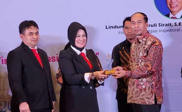 Kepala LL-DIKTI Wilayah 7 Jawa Timur Prof Dr Dyah Sawitri SE MM, menyerahkan penghargaan pada Rektor Umsida Dr Hidayatullo MSi. dok/Umbsida 
