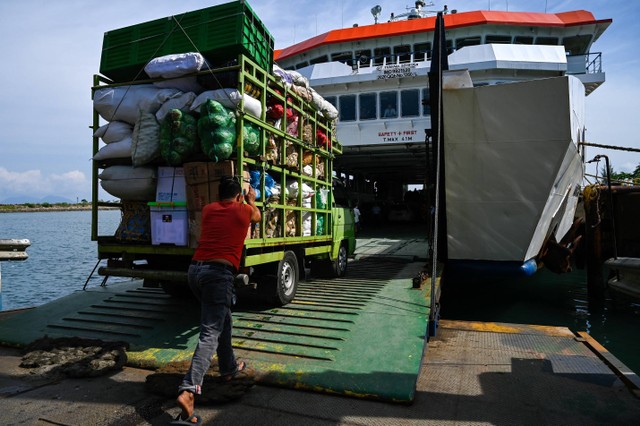 Seorang portir membantu truk pengangkut sayur-sayuran menaiki Kapal untuk menyeberang ke Pulau Sabang di pelabuhan Ulee Lheue, Banda Aceh, Aceh, Sabtu (31/12/2022).  Foto: Chaideer Mahyuddin/AFP