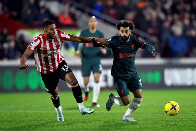 Pemain Liverpool Mohamed Salah berebut bola dengan pemain Brentford  pada apertandingan lanjutan LIga Inggris di Stadion Komunitas Brentford, London, Inggris. Foto: Toby Melville/REUTERS