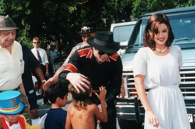 Bintang pop AS Michael Jackson dan istrinya Lisa-Marie Presley menyapa anak-anak di Budapest tertanggal 6 Agustus 1994. Foto: AFP