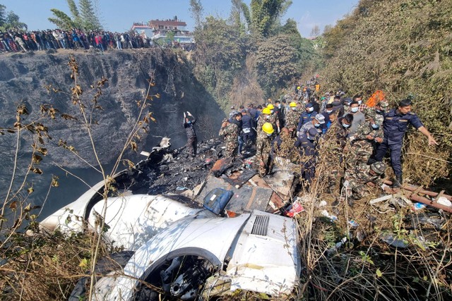 Tim penyelamat mengevakuasi korban jatuhnya pesawat  Yeti Airlines di Pokhara, Nepal, Minggu (15/1/2023).  Foto: Bijay Neupane/via REUTERS
