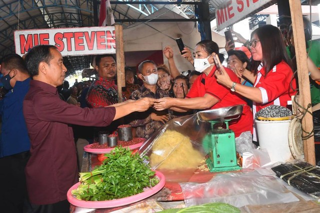 Presiden Jokowi (kemeja merah marun) mengunjungi serta membagikan bansos kepada para pedagang di Pasar Pinasungkulan, Kota Manado, Kamis (19/1/2023). Foto: Rusman/Biro Pers Sekretariat Presiden