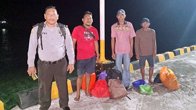 Kepala Sub Sektor Makalehi, Aipda Gat Jefry Johanis bersama Kapitalau (Kepala Desa) Desa Makalehi Induk, Stevenly Tatangindatu  dan dua nelayan asal Filipina di Pelabuhan Makalehi sebelum menuju Pulau Siau.