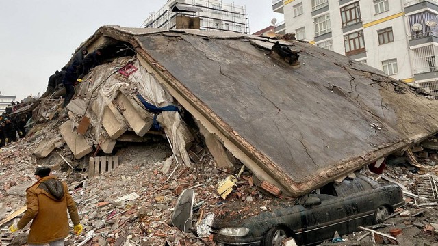 Sejumlah warga dan tim penyelamat mencari korban gempa yang tertimpa bangunan di Diyarbakir, Turki, Senin (6/2/2023). Foto: Sertac Kayar/Reuters