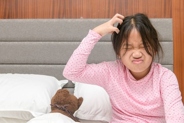 Ilustrasi anak dengan keluhan kutu rambut pada kepalanya. Foto: Shutterstock.com