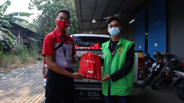 Fahmi (Ksatria JNE) melakukan serah terima paket sembako kepada pihak BOGOR GERCEP  untuk masyarakat Bogor yang menjalani isolasi mandiri.
