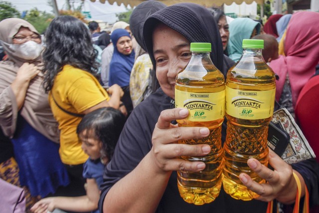 Warga menunjukkan minyak goreng Minyakita yang dibelinyaa saat gerakan pangan murah di Karadenan, Kabupaten Bogor, Jawa Barat, Kamis (23/2/2023). Foto: FOTO/Yulius Satria Wijaya