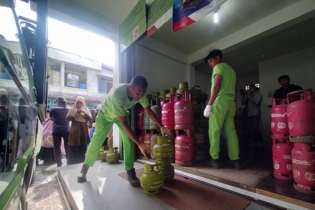 Petugas pangkalan LPG 3 Kg di Banda Aceh menurunkan sejumlah tabung gas dari atas mobil untuk dibagikan kepada masyarakat,  Jumat (24/2). Foto: Zuhri Noviandi/kumparan