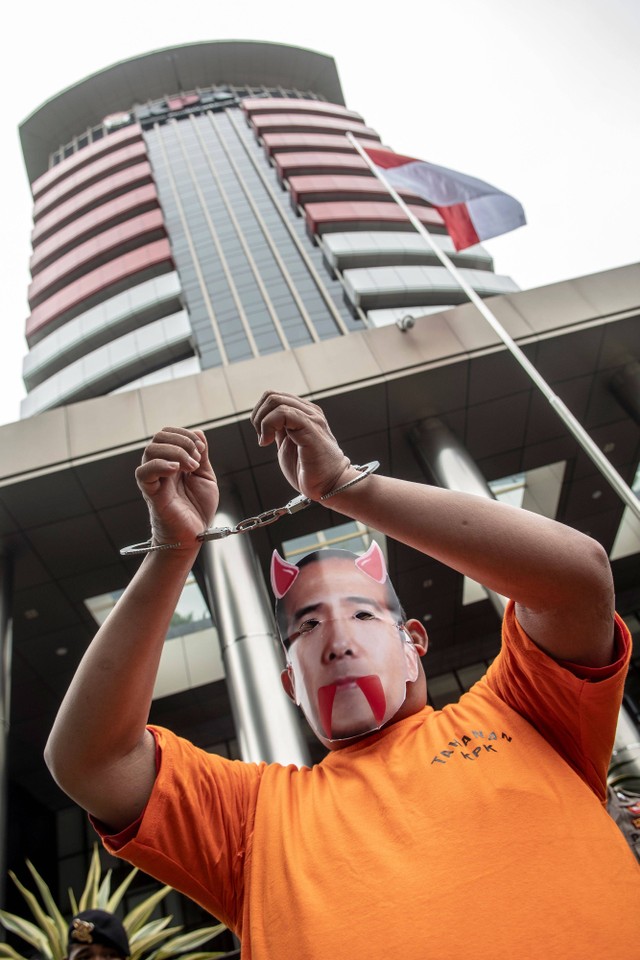 Seorang massa aksi menggunakan topeng Harun Masiku saat berunjuk rasa terkait buronan KPK yang juga Politisi PDI Perjuangan Harun Masiku di depan gedung KPK Merah Putih, Jakarta, Rabu (8/3/2023). Foto: Muhammad Adimaja/Antara Foto