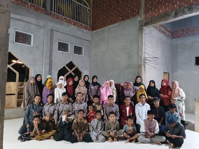 BEM dan IMM FKIP UM Buton berfoto bersama anak yatim piatu Pondok Pesantren Salafiyah Madinatul Qur'an (Sumber: Dok. BEM FKIP UM Buton)