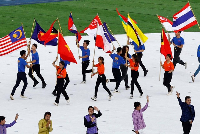 Penampil membawa bendera negara peserta selama upacara pembukaan SEA Games 2023, di Stadion Nasional Morodok Techo, Phnom Penh, Kamboja, Jumat (5/5/2023). Foto: Kim Kyung-Hoon/REUTERS