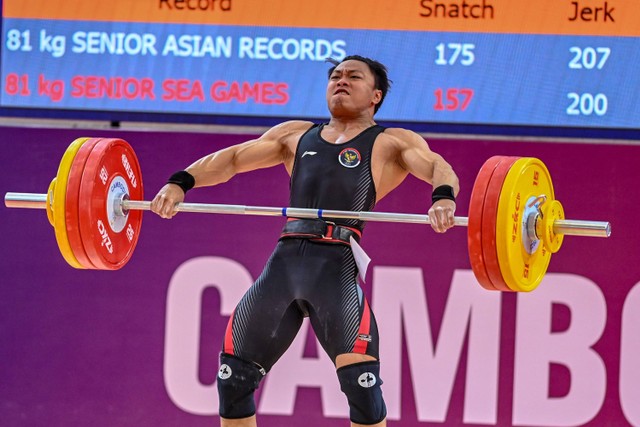 Lifter putra Indonesia Rahmat Erwin Abdullah melakukan angkatan snatch pada kelas 81 kg putra SEA Games 2023 di Taekwondo Hall, Olympic Complex, Phnom Penh, Kamboja, Senin (15/5/2023). Foto: Muhammad Adimaja/Antara Foto