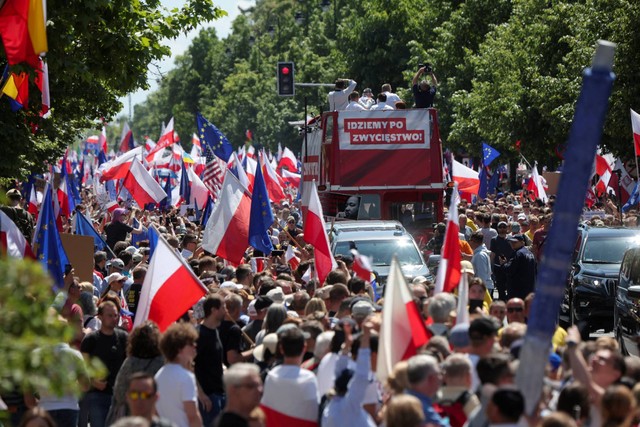 Orang-orang mengikuti protes anti-pemerintah yang dipimpin oleh pemimpin partai oposisi tengah Donald Tusk, di Warsawa, Polandia, Minggu (4/6/2023). Foto: Kacper Pempel/REUTERS