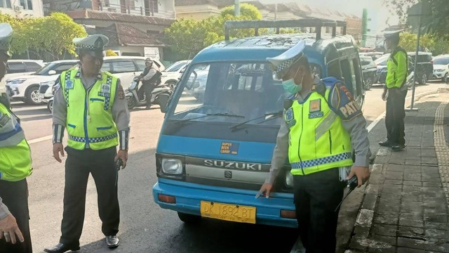 Polisi tilang WN Amerika Serikat yang kendarai angkot di Bali. Foto: Polresta Denpasar