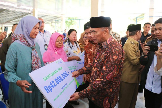 Menko PMK Muhadjir Effendy menyerahkan santunan BPJS Ketenagakerjaan kepada ahli waris dari pekerja yang meninggal dunia di Lampung Utara. Foto: Dok. BPJS Ketenagakerjaan