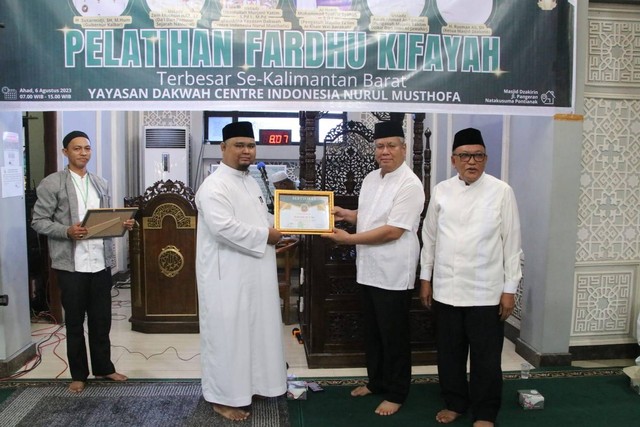 Sekda Kalbar Harrison menerima cendramata dari Pembinaan Yayasan Dakwah Center Indonesia Nurul Mustofa. Foto: Adpim Pemprov Kalbar