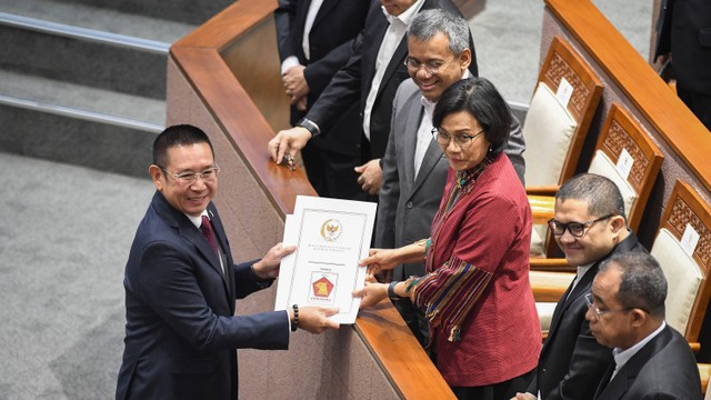 Menteri Keuangan Sri Mulyani  menerima berkas pandangan Fraksi Gerindra dari anggota DPR Wihadi Wiyanto saat Rapat Paripurna membahas Rancangan Undang-Undang (RUU) APBN 2024 di kompleks Parlemen, Senayan. Foto: ANTARA FOTO/Aditya Pradana Putra