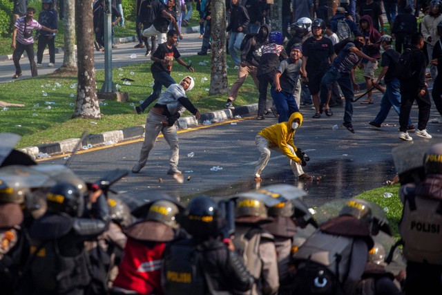 Pengunjuk rasa melempari personel polisi saat aksi unjuk rasa warga Pulau Rempang di Kantor Badan Pengusahaan (BP) Batam, Batam, Kepulauan Riau, Senin (11/9/2023). Foto: Teguh Prihatna/ANTARA FOTO