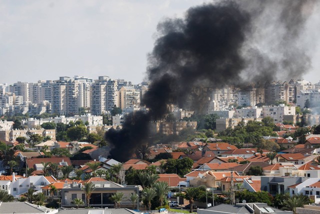 Pemandangan udara menunjukkan kendaraan terbakar saat roket diluncurkan dari Jalur Gaza, di Ashkelon, Israel selatan, Sabtu (7/10/2023). Foto: Ilan Rosenberg/REUTERS