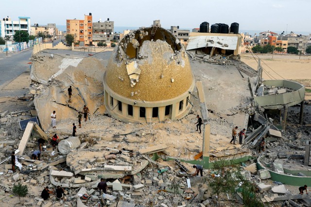 Warga memeriksa sebuah masjid yang hancur akibat serangan Israel di Khan Younis, di Jalur Gaza, Minggu (8/10/2023).  Foto: Ibraheem Abu Mustafa/REUTERS