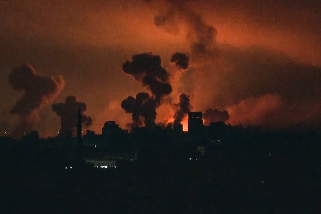 Api dan asap membubung di atas Kota Gaza selama serangan Israel pada 27 Oktober 2023, Foto: YOUSEF HASSOUNA/AFP