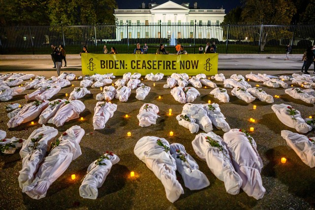 Sejumlah instalasi jenazah berkain putih yang mewakili para korban konflik Israel-Hamas, terlihat tergeletak di depan Gedung Putih di Washington, DC, AS, Rabu (15/11/2023). Foto: Mandel Ngan/AFP