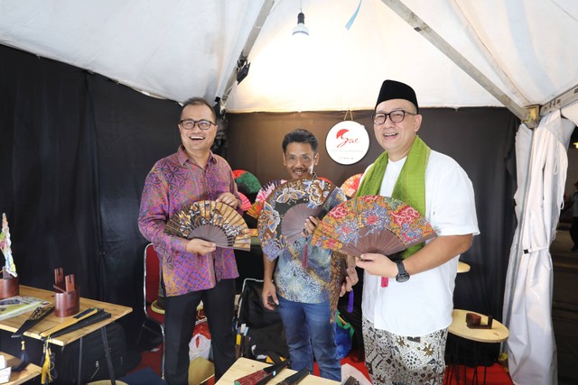 Direktur Strategic Portfolio Telkom, Budi Setyawan Wijaya (kiri) didampingi SVP Corporate Communication & Investor Relation Telkom Ahmad Reza (kanan) mengunjungi salah satu UMKM binaan Telkom dalam acara “Harvesting Day” sebagai acara puncak Gerakan Nasional Bangga Buatan Indonesia (Gernas BBI) dan Bangga Berwisata di Indonesia (BBWI) di Taman Fatahillah, Jakarta Barat (19/11). Foto: dok. Telkom