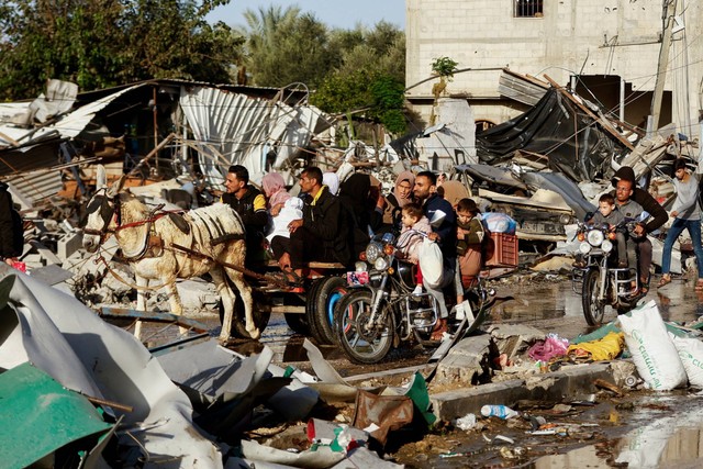 Warga Palestina menaiki kereta keledai saat mereka kembali ke rumah mereka, selama gencatan senjata sementara antara Hamas dan Israel, di Khan Younis di selatan Jalur Gaza, Jumat (24/11/2023). Foto: Ibraheem Abu Mustafa/REUTERS