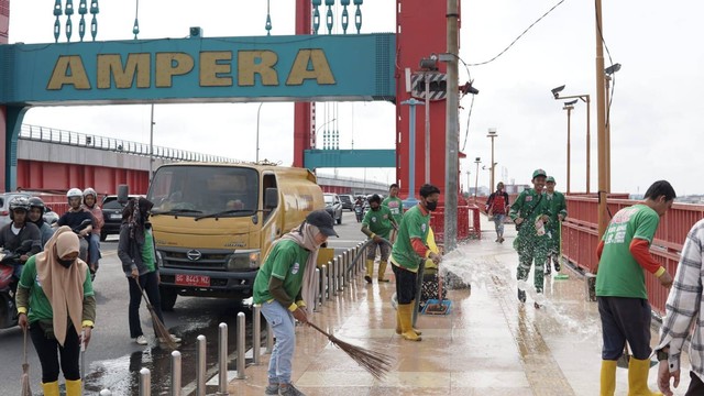 Petugas Hijau bersama Dinas Kebersihan Pemkot saat membersihkan Jembatan Ampera Paelmbang, Foto : Istimewa