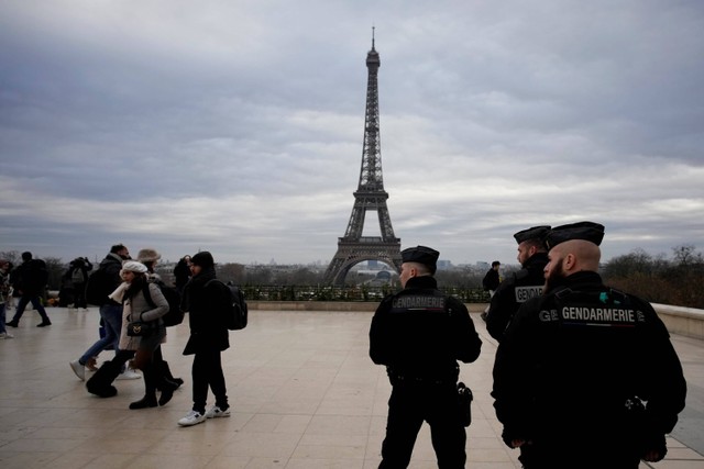 Polisi Prancis berpatroli di alun-alun Trocadero dekat Menara Eiffel setelah penikaman yang terjadi pada Sabtu (2/11/2023) malam. Foto: Christophe Ena/AP Photo