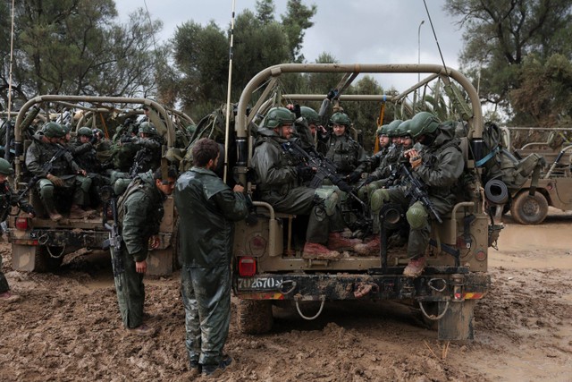 Tentara Israel bersiap memasuki Jalur Gaza, di tengah konflik yang sedang berlangsung antara Israel dan kelompok Islam Palestina Hamas, di perbatasan Israel dengan Gaza di Israel selatan, 13 Desember 2023. Foto: Ronen Zvulun/Reuters