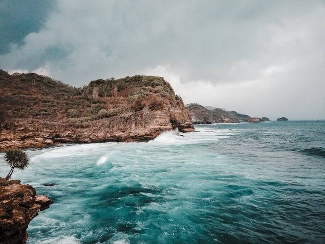 Ilustrasi Pantai dengan Tebing di Bali (Foto hanya ilustrasi, bukan tempat sebenarnya) Sumber: unsplash.com/ Aaron Kiru