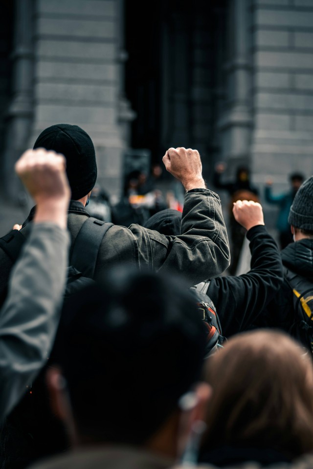 https://unsplash.com/photos/people-in-black-jacket-standing-on-street-during-daytime-T7fu-VMQPlE