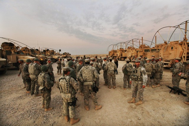 Prajurit dari Brigade ke-3, Divisi Kavaleri ke-1, menunggu untuk memulai patroli internal di Kamp Adder, yang sekarang dikenal sebagai Pangkalan Imam Ali, Irak, pada 16 Desember 2011. Foto: MARIO TAMA / POOL / AFP